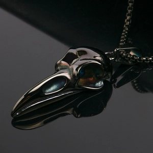 Gothic eagle skull pendant necklace with iridescent finish on a reflective black base