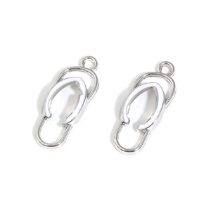 Macro detail of alloy flip-flop pendants with silver finish and white enamel for DIY jewelry