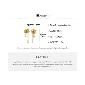 Macro detail of gold-plated cluster earrings with cubic zirconia and silver needles