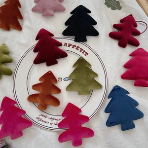 Close-up of velvet Christmas tree ornaments in various colors with hanging holes