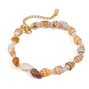 Macro shot of seashell anklet with S.STEEL engraved gold lobster clasp and extension chain