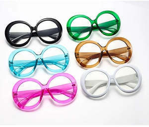Multiple colors of round oversized fashion glasses frames arranged on white background