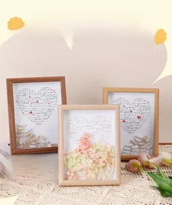 Detail of 3D shadow box frame with dried flowers and capsule collage gift