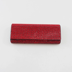 Detailed view of a luxury red rhinestone-encrusted hard shell eyeglass case.
