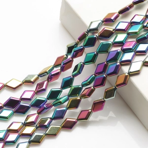 Close-up of diamond-shaped crystal glass beads with rainbow electroplated metallic finish