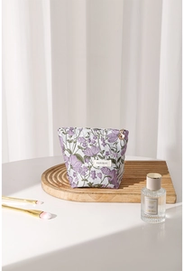 Detail of lavender floral embroidery on canvas cosmetic bag with flower zipper puller