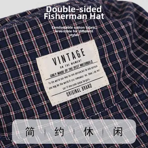 Detail shot of blue and red plaid cotton fabric and vintage label on a bucket hat