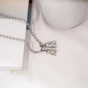 Close-up of double teddy bear pendants with sparkling crystals and silver ball chain