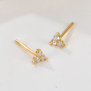 Detail view of 18K gold plated S925 silver stud earrings with three round zircon stones