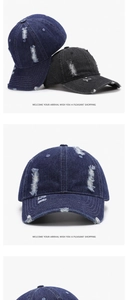 Close-up of distressed denim baseball cap detailing frayed edges and vintage holes