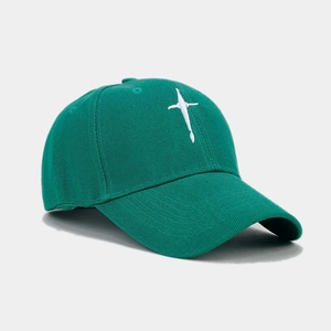 Detail of white star embroidery on dark green cotton canvas baseball cap surface