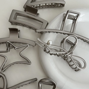 Elegant grey metal hair claws in various shapes like star and rectangle for women