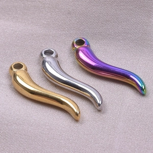 Detail view of gold, silver, and rainbow chili pepper charms for DIY jewelry making
