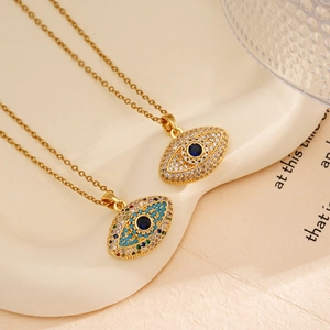 Elegant 18K gold plated Evil Eye necklace with blue zircon pendant on ceramic tray