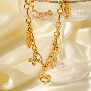 Detailed shot of golden necklace with evil eye and sun charms over beige satin cloth