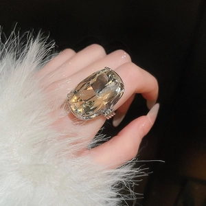 Macro view of cushion-cut champagne gemstone ring with micro-pave diamond setting