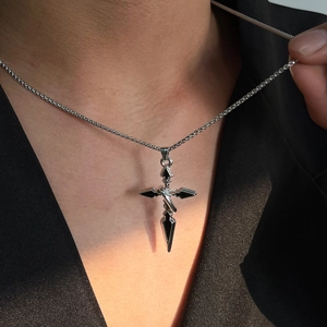 Gothic cross sword pendant necklace in silver finish worn on black blazer outfit