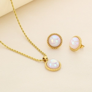 Detailed view of pearl-inlaid gold twist chain necklace and matching stud earrings set