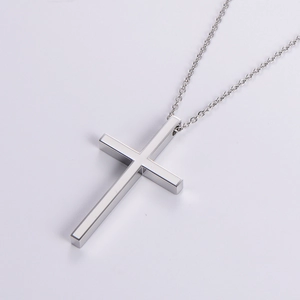 Minimalist silver stainless steel cross pendant necklace with polished finish on white base