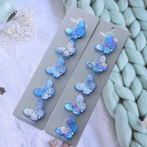Close-up of a 10-piece set of gradient blue butterfly hair clips on display cards