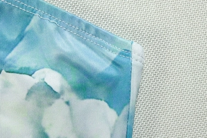 Detail of blue and white abstract print dress with high-quality double-needle stitching