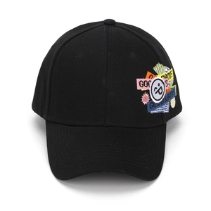 Detail of colorful GOOD BOYS embroidery patches on a black cotton baseball cap
