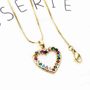 Detail of a gold-plated heart pendant necklace with multi-colored micro-set zircons on chain