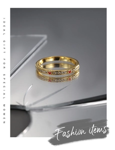 Macro shot of gold plated heart ring with red enamel and pavé cubic zirconia details