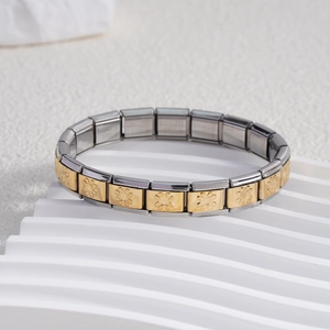 Italian charm bracelet in stainless steel featuring gold daisy flower embossed links