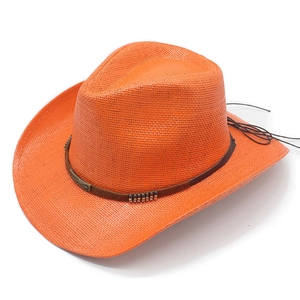 Detail of orange woven straw cowboy hat featuring brown leather band and metallic buckle