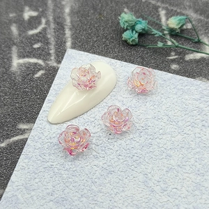 Macro shot of 3D aurora camellia nail charms with translucent rose petal details