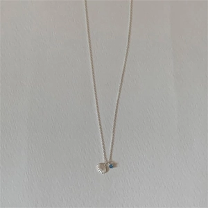 Minimalist 925 sterling silver necklace featuring shell pendant and blue zircon accent