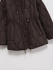 Detail of wave quilted hooded coat with gold zipper and adjustable drawstring waist