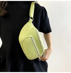 Detailed view of light green PU leather chest bag with adjustable strap and silver zipper