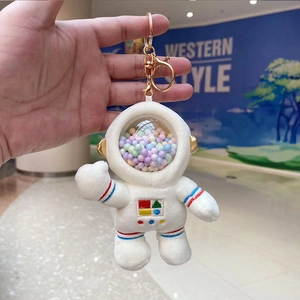 Close-up of plush astronaut bunny keychain with colorful beads in clear helmet visor