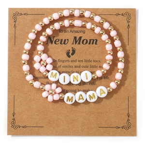 Detailed view of pink beaded MAMA and MINI matching bracelet set for mother and child