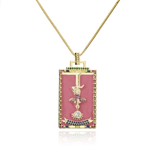 Macro shot of 18K gold plated Hanged Man tarot card pendant with pink enamel and crystals
