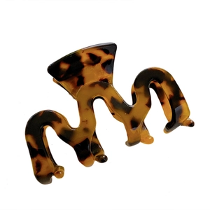Small tortoiseshell geometric hair claw clip with wave pattern on white background