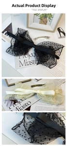 Detail of the oversized French polka dot mesh bow hair clip with metal spring fastener