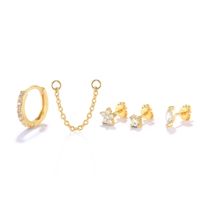 Macro shot of 5-piece gold S925 silver earring set with sparkling zircon studs and chains