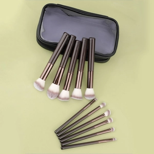 Macro shot of 12-piece professional makeup brushes with wooden handles and storage bag