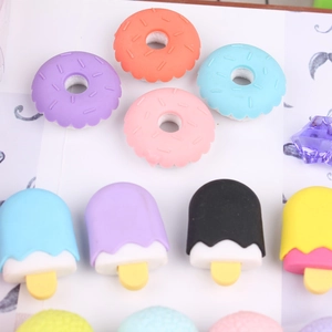 Macro shot of cute donut and popsicle shaped erasers in various vibrant colors
