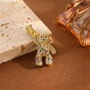Close-up of golden panda pendant encrusted with multi-colored crystals and gemstones