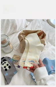 Detail of cute cotton crew socks featuring 3D cartoon bear patterns in home setting