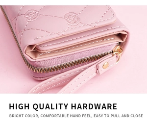 Close-up of pink embroidered wallet featuring gold hardware and smooth zipper detail
