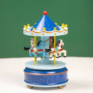 Detail of royal blue carousel music box with hand-painted horses and gold star accents