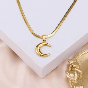 Detailed close-up of 18K gold plated flat snake chain necklace with crescent moon pendant