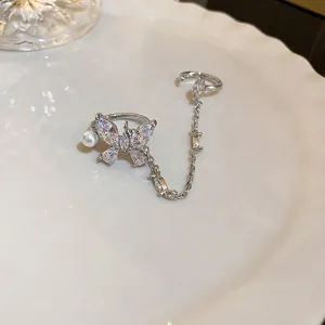 Elegant silver butterfly jewelry set with sparkling zircons and pearls on white plate