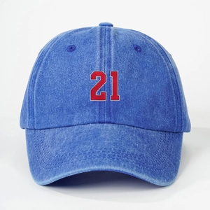 Close-up of blue washed cotton baseball cap featuring embroidered number 21 on the front
