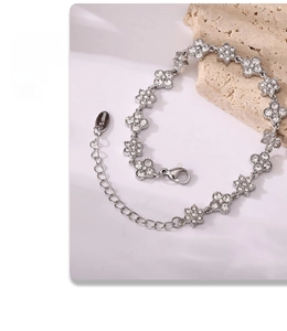 Macro detail of silver flower bracelet showing cubic zirconia inlay and S.steel tag